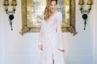 20 a modern wedding dress with a side slit, bell sleeves, a V-neckline and embellishments here and there