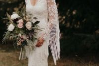 21 Jenna boho lace sheath gown with a V-neckline, a capelet with long fringe and a train