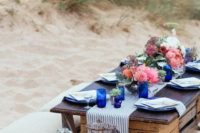 22 a beach wedding picnic table placed on crates is a nice idea which won’t cost much