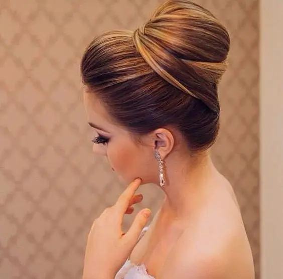 an elegant tight top knot with twists and a bump is always a good idea if you have long hair