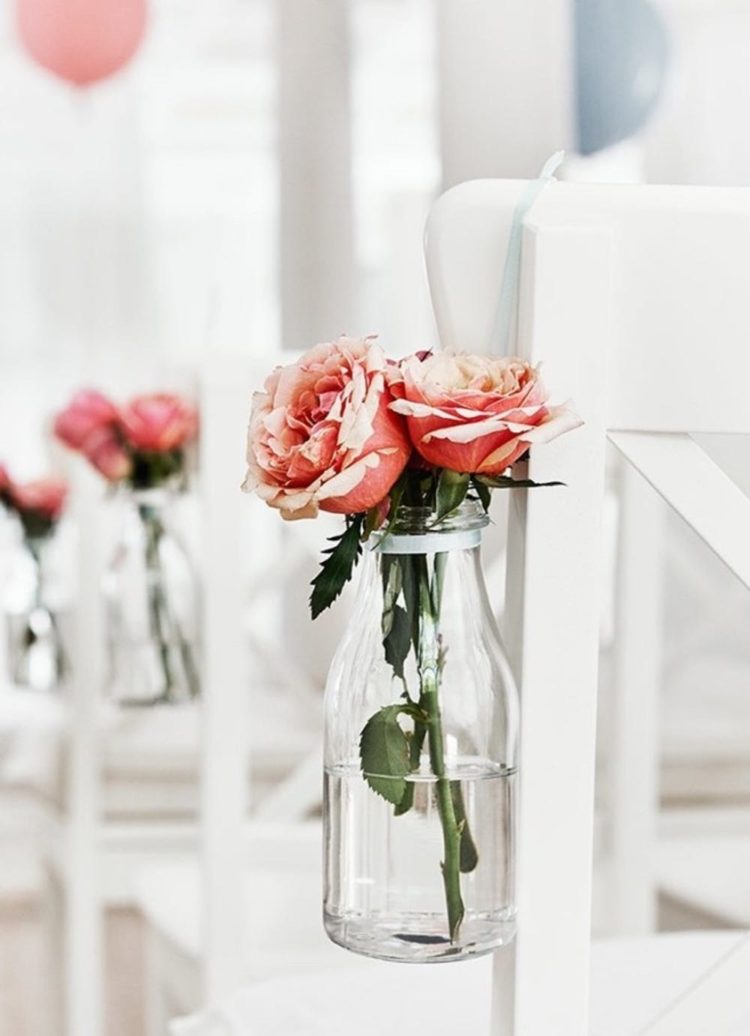 decorate the aisle chairs attaching Ensidig vases with blooms to them