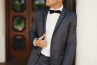 23 a graphite grey tuxedo with black rim lapels and a black bow tie is a fresh take on a traditional black one