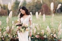23 a wild rustic ceremony space done with pampas grass, leaves and blooms