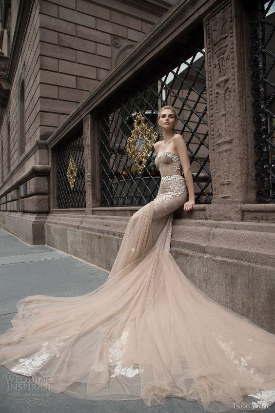 a breathtaking strapless mermaid wedding dress with rhinestones and appliques and a long train for a wow effect