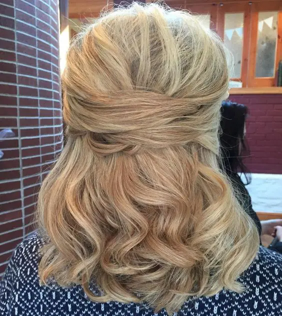 a chic half updo with twists and curly hair down for middle length hair