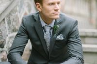 24 a grey two piece suit, a lavender shirt, a grey printed tie with a greenery boutonniere for a modern look