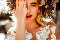 25 an oversized floral crown with blush, red and white blooms and textural greenery for a fall boho bride