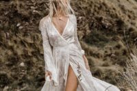 26 Wild Harlow wedding dress with long bell sleeves, a deep V-neckline and a thigh high slit plus lace appliques