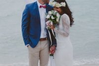 a beach groom wearing a bold blue blazer paired with a pink bow tie for a bold look