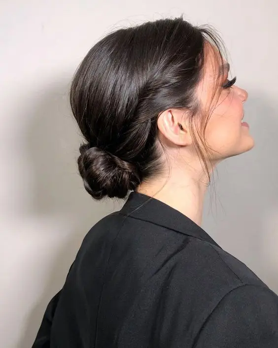 a beautiful and sleek low bun with twists surrounding the head and locks down is a lovely idea for a mother of the bride or groom