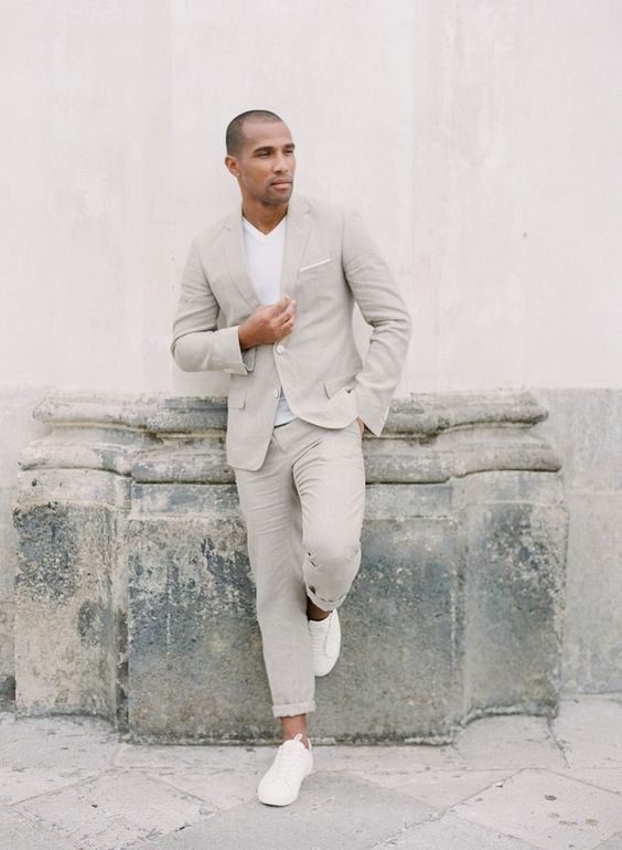 a casual groom's look with a grey linen suit, a white t-shirt, white sneakers is a great idea for a hot day wedding