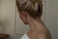 a classic messy and wavy top knot, messy and wavy hair are a fresh and modern idea for a modern mother of the bride or groom look