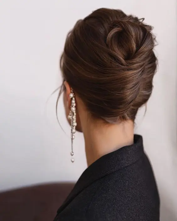 a classy French twist updo with a bump on top and some hair down is a cool idea that always works