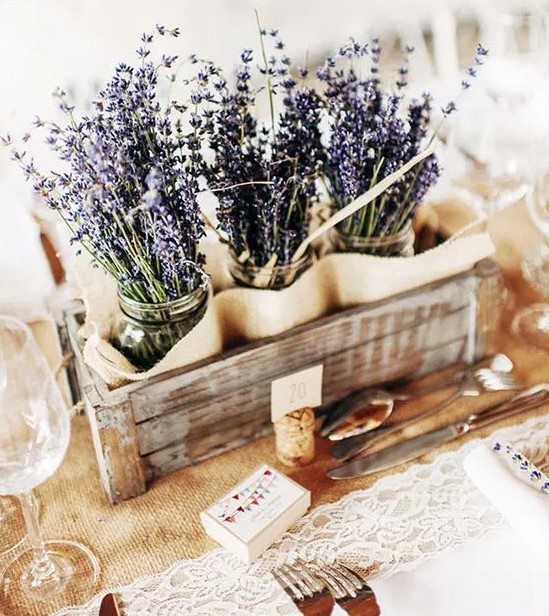 a crate with lavender in jars is a great rustic centerpiece, it's perfect for summer weddings