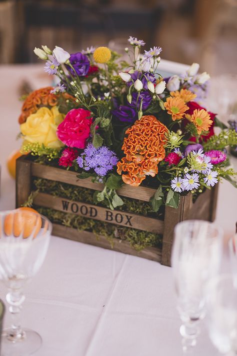 a crate with moss and super bright blooms is a perfect summer wedding centerpiece that you can make in minutes