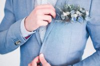 a delicate coastal groom’s look with a light blue suit, a polka dot shirt, a blue flower pocket square is amazing