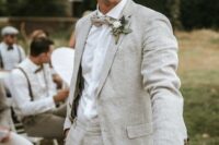 a dove grey linen suit, a white shirt, a light grey bow tie and a white flower boutonniere are great for summer