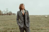 a fall groom’s outfit with a grey pantsuit, a black waistcoat, a white shirt, a rust tie and amber shoes