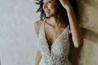 a glam A-line wedding dress with a sparkling bodice, thick straps and a layered skirt with a touch of sparkle is a gorgeous idea