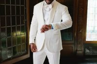 a glam groom’s outfit with a white tux, a white and a bow tie, white loafers and a chain is amazing for summer