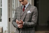 a grey checked three-piece suit, a white shirt, a burgundy bow tie and a brown belt for a touch of vintage