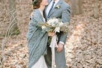 a grey suit for the groom and a grey knit coverup for the bride is a chic idea for a winter wedding and for couple’s portraits