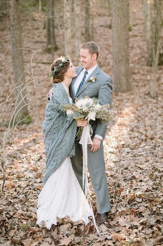a grey suit for the groom and a grey knit coverup for the bride is a chic idea for a winter wedding and for couple's portraits