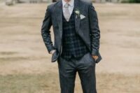 a grey tweed suit, a white shirt, a grey and navy waistcoat, a grey tie and brown shoes are a great combo