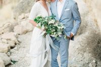 a light blue suit paired with a white shirt is a cool effortlessly chic groom’s look for a coastal or beach wedding