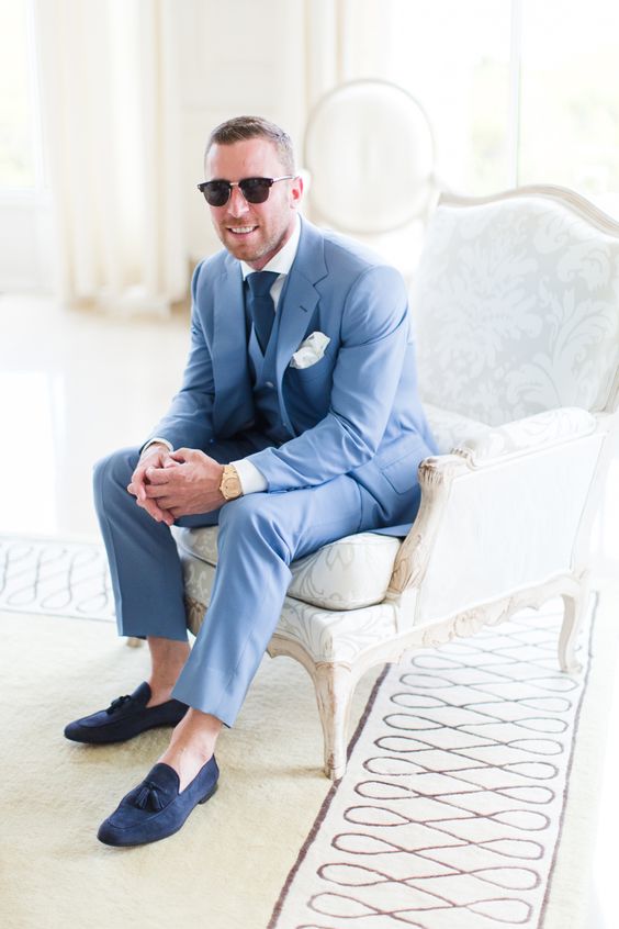 a lovely coastal groom's look with a blue three-piece suit, a white shirt, a navy tie and navy loafers is pure elegance