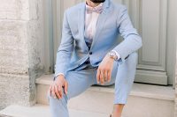 a lovely pale blue three-piece pantsuit, a white shirt, a printed bow tie, white sneakers and a watch compose a cool look for summer