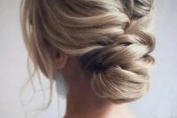 a messy and voluminous low chignon with a large bump on top and locks down is gorgeous