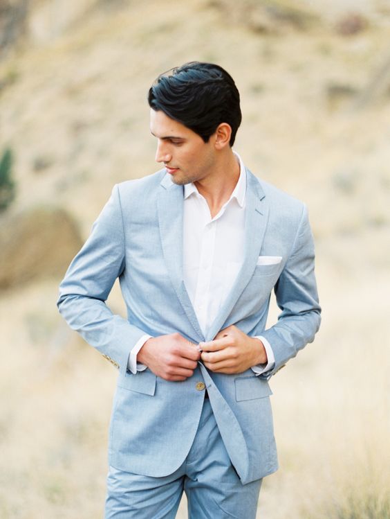a minimal coastal groom's look with a white shirt, a pale blue suit is a cool and stylish idea to rock