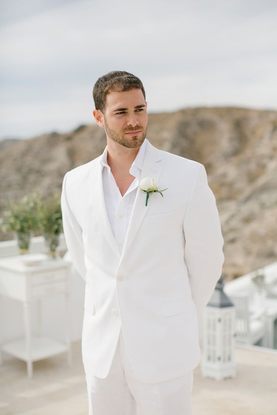 a minimal white groom's look with a suit and a shirt plus a boutonniere is a lovely idea for a spring or summer wedding