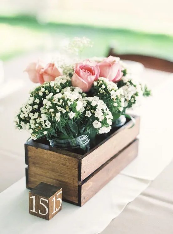 a pallet box with jars with white and pink blooms is a simple idea for a rustic wedding
