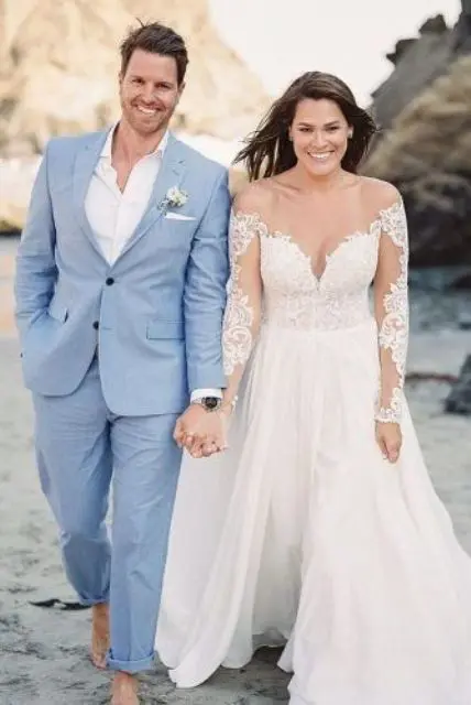 a perfect coastal groom's look with a pale blue suit, a white shirt, no shoes or a tie is amazing