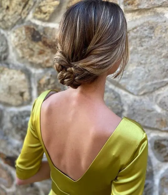 a refined braided low updo with a sleek top and face-framing locks is a stylish idea for mothers with long hairs