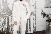 a refined modern groom’s look with a white suit, shirt, brown shoes and a coral boutonniere is wow