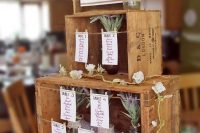 a rustic wedding seating chart of crates, with table names, blooms and greenery can be made fast and easily