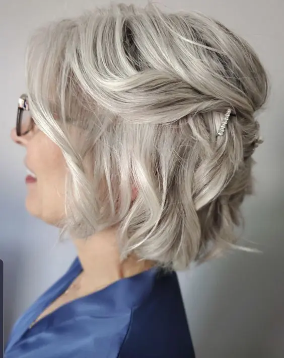 a simple and elegant half updo with rhinestone hairpins and waves is a cool idea for short and medium hair, it's stylish and effortless