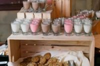 a simple cookie bar with a crate, fresh cookies placed on fabric and some milk in glasses