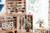 a simple rustic wedding decoration of crates, bold blooms and greenery, monograms and burlap ribbon is amazing