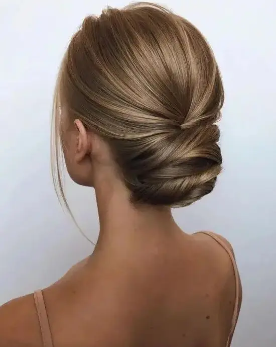 a sophisticated modern twisted updo with a sleek yet dimensional top and a bit of locks to frame the face is a great idea for a formal wedding