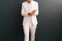 a stylish and all-minimal groom’s outfit with a white suit and a shirt plus black velvet loafers is a lovely solution