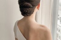 a stylish and elegant twisted low updo with a sleek top is a cool idea for a refined mother of the bride look