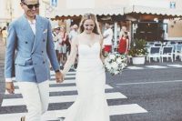 a stylish groom’s outfit with a blue blazer, a white shirt and pants and brown moccasins for a coastal Italian wedding