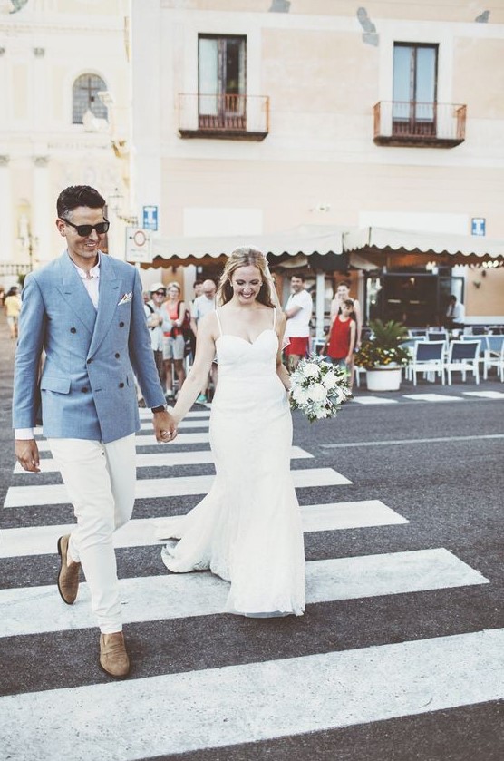 a stylish groom's outfit with a blue blazer, a white shirt and pants and brown moccasins for a coastal Italian wedding