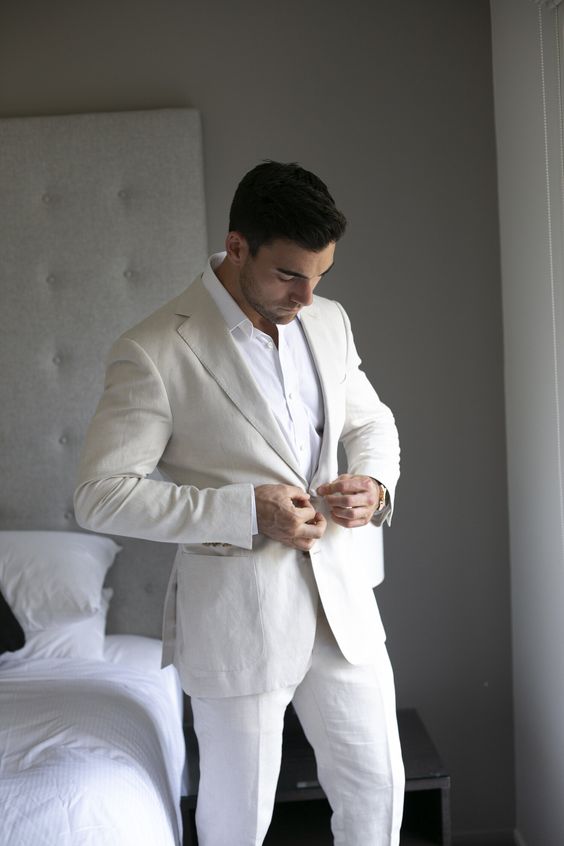 a stylish summer groom's look with a linen pantsuit, a white shirt and nothing else is cool, minimal and lovely