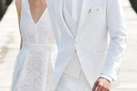 a white modern groom’s look with a three-piece suit with a patterned waistcoat and a bow tie is amazing