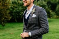 a white shirt, a navy waistcoat and pants, a grey plaid blazer, a white handkerchief and a boutonniere are a lovely combo
